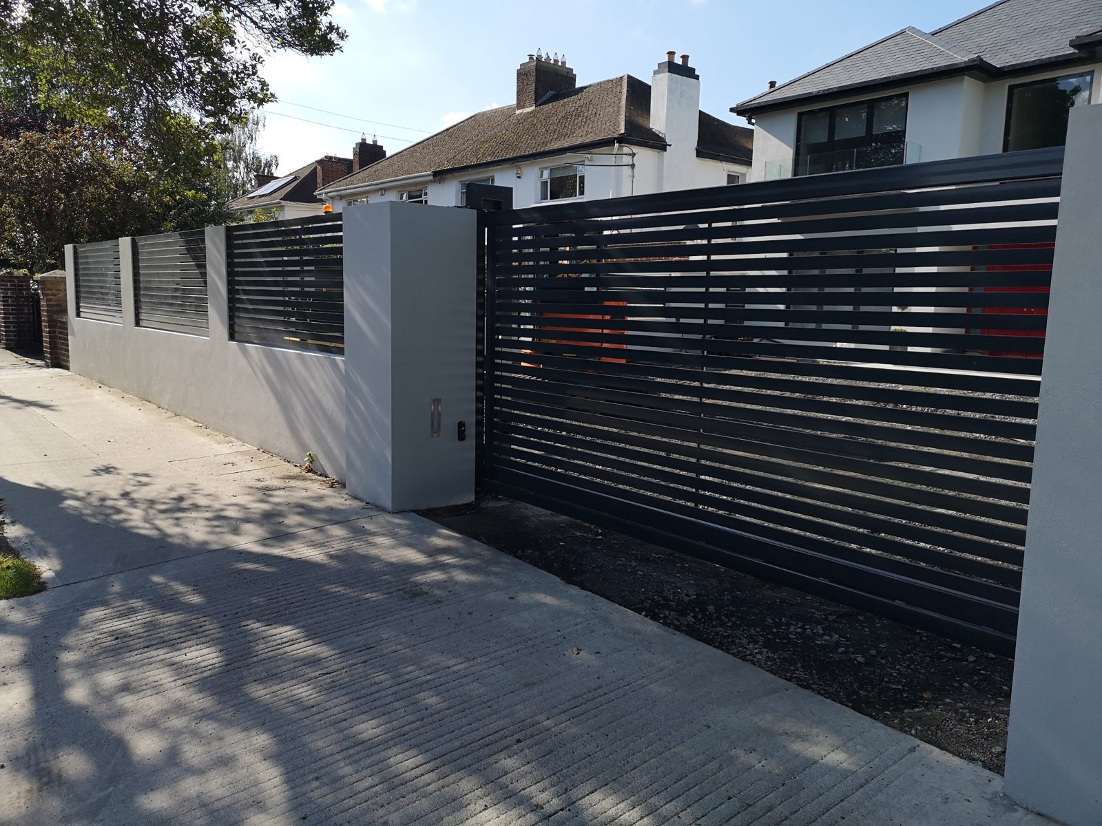 Sliding gates with matching wall panels like these for homes in Bangor